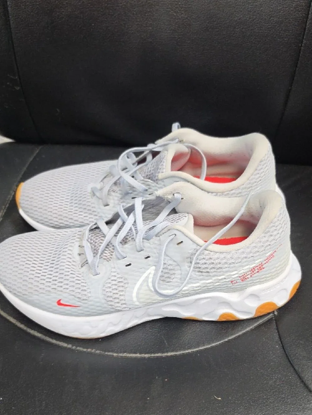 Nike Women's Light Gray Athletic Sneakers with Orange and Red Accents